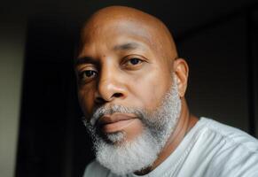 Captivating Portrait of an Older Man With a Distinguished Beard in a Soft Indoor Light photo