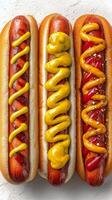 Classic Hot Dogs Topped With Mustard and Ketchup Arranged on a White Surface photo