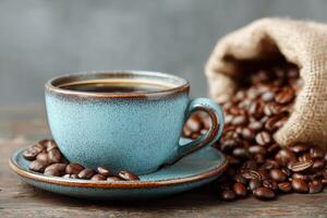 Warm Cup of Coffee With Roasted Beans Spilling From a Burlap Sack on Rustic Wooden Surface photo