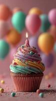 Colorful Cupcake With Frosting and Candle Surrounded by Festive Balloons for Celebration photo