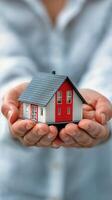 Model House Held in Hands Representing Homeownership and Dreams of a New Beginning photo