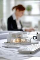 Architectural Model Displayed on Desk With Professional Reviewing Plans in Modern Office Environment photo