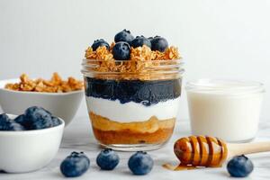 Delicious Layered Dessert Featuring Yogurt, Granola, and Blueberries in a Jar photo