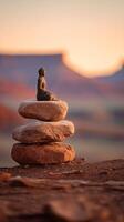 Balanced Stones With a Serene Figure During Sunrise in a Desert Landscape photo