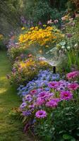 Colorful Garden in Full Bloom With Sprinkler Watering Flowers on a Sunny Day. photo
