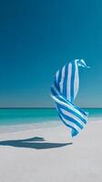 Colorful Beach Towel Dances in the Ocean Breeze on a Sunny Day. photo