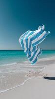 Colorful Beach Towel Dances in the Ocean Breeze on a Sunny Day photo