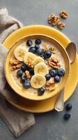 Healthy Breakfast Bowl With Bananas, Blueberries, and Walnuts Served on a Colorful Plate. photo