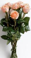 Fresh Peach Roses Bundled With Green Leaves for Elegant Decoration or Gifting Purposes photo