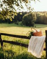Bask in the Tranquility of a Sunny Field With a Rustic Basket and Cozy Blanket in a Serene Countryside photo