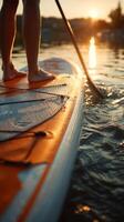Paddleboarding at Sunset on a Calm Lake With Soft Ripples and Warm Light photo