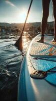 Paddleboarding at Sunset on a Calm Lake With Soft Ripples and Warm Light. photo