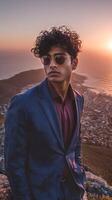 Stylish Man in Suit Enjoying Sunset View Over City and Ocean From Mountain Peak photo