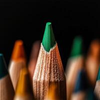 Green Pencil Tip Stands out Among Colorful Sharpened Pencils in Dark Background photo