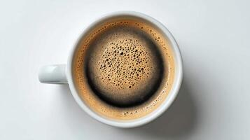 Freshly Brewed Coffee in a White Mug Showcasing Rich Foam and Dark Color photo