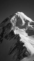 Majestic Snow-Covered Peak Surrounded by Dark Sky at High Altitude During Winter Season. photo