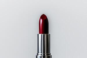 Elegant Red Lipstick on a Clean Surface Showcasing Its Glossy Finish and Vibrant Color photo