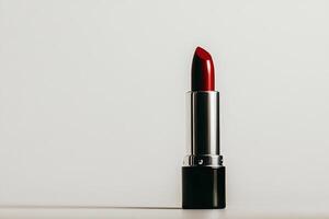 Elegant Red Lipstick on a Clean Surface Showcasing Its Glossy Finish and Vibrant Color. photo