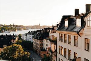Sunset Over the Waterfront Buildings in Stockholm, Showcasing Beautiful Architecture and Serene Waters photo