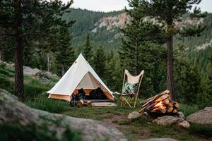 Cozy Camping Setup in the Mountains With Tent, Chair, and Campfire at Sunset photo