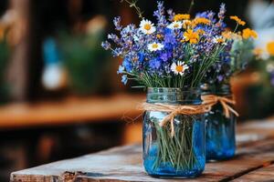 Brightly Colored Wildflowers in Jars on a Wooden Table During a Sunny Afternoon Outdoors. photo