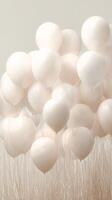 Bunch of White Balloons Floating Above Tall Grass in a Serene Landscape During Cloudy Weather. photo