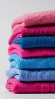 Colorful Knitted Sweaters Stacked Neatly for a Cozy Display on a Light Background. photo