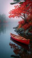 Canoe Anchored in Tranquil Water Amidst Vibrant Autumn Foliage photo