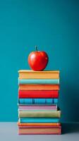 Stacked Colorful Books With a Red Apple Placed on Top for a Creative Learning Concept. photo