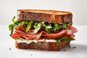 Delicious Sandwich With Ham, Tomato, and Arugula on Whole Grain Bread. photo
