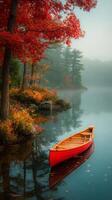 Canoe Resting on Calm Lake Surrounded by Vibrant Autumn Foliage in Early Morning Mist. photo
