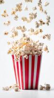 Popcorn Falling From a Striped Container Creates a Fun and Lively Atmosphere photo