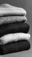 Cozy Arrangement of Folded Wool Sweaters in Neutral Tones Indoors photo