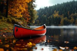 Red Canoe on a Tranquil Lake Surrounded by Autumn Trees During Rain in a Mountainous Region photo