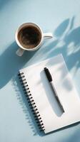 Morning Coffee With a Notebook and Pen on a Light Blue Table photo