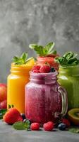 Refreshing Fruit Smoothies in Glass Jars With Mint Leaves and Fresh Berries on a Gray Background photo