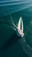 Sailing Yacht Gliding Across Calm Blue Waters in Bright Sunlight on a Clear Day photo