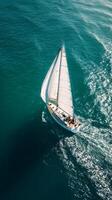 Sailing Yacht Gliding Across Calm Blue Waters in Bright Sunlight on a Clear Day. photo
