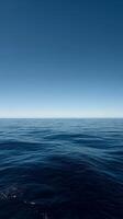 Tranquil Ocean View Under a Clear Blue Sky at Midday. photo