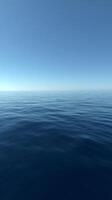 Calm Ocean Surface Under a Clear Blue Sky on a Serene Day by the Coast photo