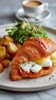Delicious Breakfast Croissant With Eggs, Salad, and Roasted Potatoes Served on a White Plate photo
