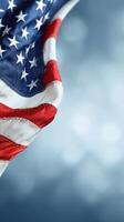Waving American Flag Against a Blurred Blue Background in Daylight photo