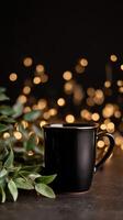 Warm Beverage in a Black Mug Beside Green Foliage With Blurred Bokeh Lights in the Background at Evening photo