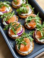 Delicious Smoked Salmon Appetizers Arranged on a Platter Ready for Serving at a Gathering. photo