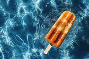 Bright Orange Popsicle Floats on Water Surface During Sunny Day photo