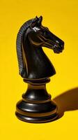 Black Chess Knight Piece Against Vibrant Yellow Background Creating Striking Visual Contrast. photo