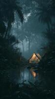 Tent Illuminated by Fire in a Lush Jungle During Heavy Rain at Dusk. photo