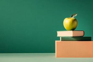 Green Apple on Stacked Books Against a Solid Color Background in a Minimalist Setup photo