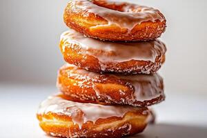 Delicious Glazed Donuts Stacked in a Tempting Arrangement for Dessert Lovers photo