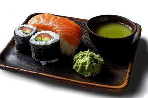 Fresh Sushi Platter Featuring Rolls and Salmon With Wasabi and Soy Sauce on Dark Ceramic Plate photo